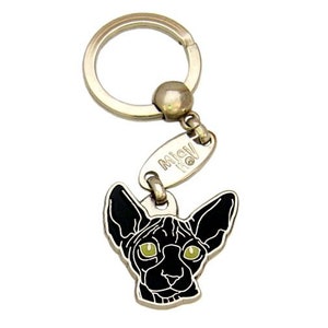 May include: A silver key chain with a black Sphynx cat charm. The charm has green eyes and the text "Miaow" on the tag.