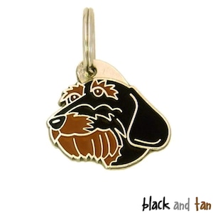 May include: Black and tan dachshund dog charm with a gold ring. The charm is made of metal and has a black and tan enamel finish.