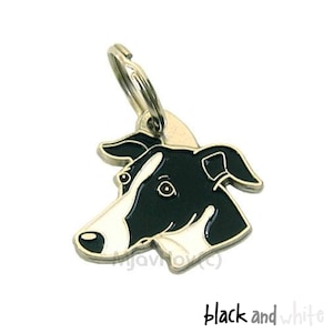 Puede incluir: Encanto de cabeza de perro blanco y negro con un llavero plateado. El encanto está hecho de metal y tiene un acabado brillante.