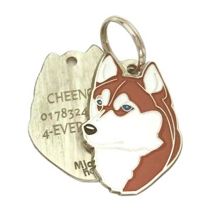 May include: A silver pet tag with a detailed husky dog design in brown, white, and red enamel. The tag includes a separate, textured metal piece with engraved text: "CHEENY 0178324 4-EVER". A silver ring is attached for easy attachment to a collar.