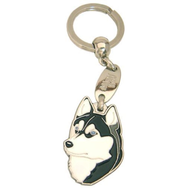 May include: A silver-colored keychain featuring a detailed, enamel-painted husky dog head. The dog's face is white with black markings and blue eyes. The keychain includes a split ring and a small tag.