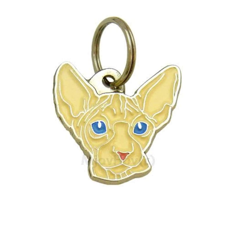 May include: A gold-colored metal cat charm with a light yellow Sphynx cat head design. The cat has blue eyes and a pink nose.