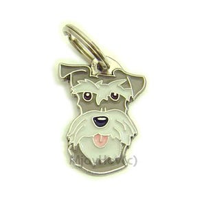 Puede incluir: Un llavero de metal plateado con una imagen de dibujos animados de un perro schnauzer gris y blanco con la lengua rosa que sobresale. El perro tiene ojos negros y una nariz negra.