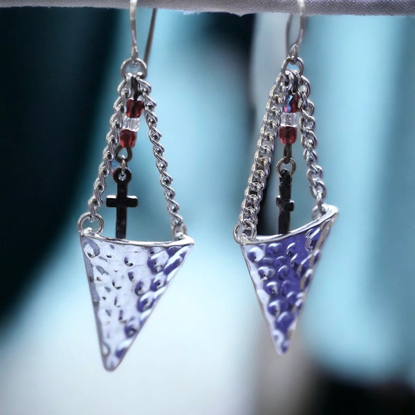 Hammered metal triangular dangle earrings with tiny crosses hanging from glass seed beads