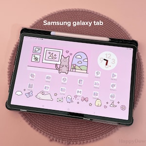 May include: A Samsung Galaxy Tab tablet with a pink and white background. The tablet has a clock widget with the time 9:73. The tablet is surrounded by a pink and white patterned case.