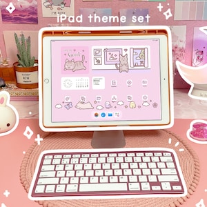 May include: A pink and white iPad theme set with a pink keyboard, a pink and white iPad case, and a pink and white moon lamp. The iPad screen shows a pink and white theme with a cat illustration and the text "Life is so sweet".