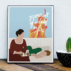 May include: A minimalist poster with a blue background and the text "Portrait of a Lady on Fire" in white cursive. The poster features a woman in a red dress and another woman lying in a bed. The poster is framed in black.