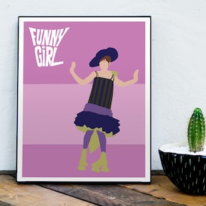 May include: A pink and purple poster with a black frame featuring a cartoon illustration of a woman wearing a purple and green dress and a black hat. The text "FUNNY GIRL" is printed in white at the top of the poster.