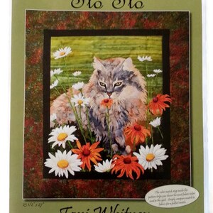 May include: A quilt pattern featuring a gray cat with green eyes sitting in a field of white and orange flowers. The pattern is called "Flo Flo" and is designed by Toni Whitney.