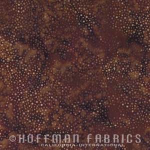 May include: Brown fabric with a speckled pattern. The fabric has a mottled appearance with lighter brown and white dots scattered across a darker brown background. The text "HOFFMAN FABRICS CALIFORNIA-INTERNATIONAL" is at the bottom.