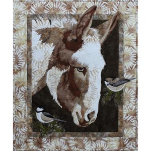 May include: A close-up of a brown and white donkey's head with two small birds perched on a branch in the background. The donkey's fur is soft and fluffy, and its eyes are large and brown. The birds are black and white with a brown stripe on their heads.