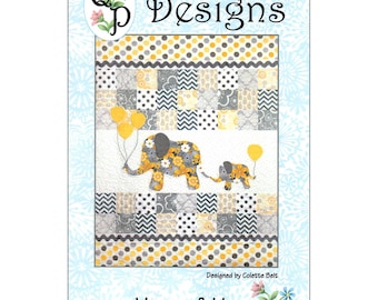 May include: A quilt pattern titled "Mommy & Me" features two elephants holding yellow balloons. The quilt design includes gray, yellow, and white patchwork with polka dots and chevron patterns. The top of the pattern reads "QP Designs".