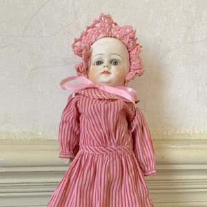 Antique bisque doll with stationary blue glass eyes c 1900