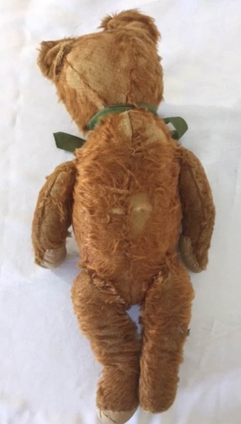 Large antique jointed straw-stuffed teddy bear with worn cinnamon-colored fur and old pad replacements 19 12