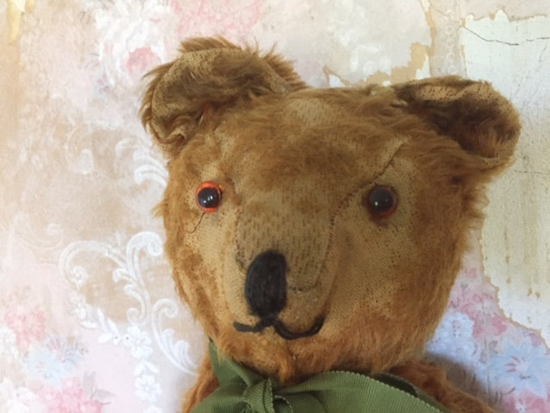 Large antique jointed straw-stuffed teddy bear with worn cinnamon-colored fur and old pad replacements 19 12