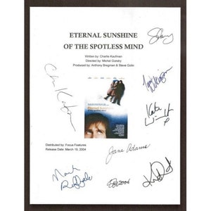 May include: A white sheet of paper with the title "Eternal Sunshine of the Spotless Mind" and the names of the cast and crew. The paper is signed by the cast and crew, including Jim Carrey, Kate Winslet, Mark Ruffalo, and Kirsten Dunst.