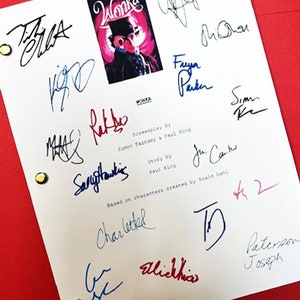 May include: A white script page with a color image of Willy Wonka from the movie "Willy Wonka and the Chocolate Factory". The page is signed by the cast and crew, including Faye Parker, Simon Farnaby, and others.