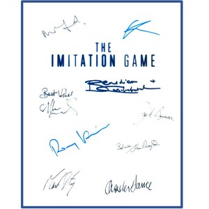 May include: A white book cover with the title "THE IMITATION GAME" in blue text. The cover is signed by several people, including Benedict Cumberbatch, Keira Knightley, and Alan Turing.