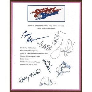 May include: A white sheet of paper with black text and blue signatures. The text reads "Smokey and the Bandit" and includes information about the film's production, including the director, producer, editor, music, studio, distributor, and release date. The signatures include those of Hal Needham, Mort Engelberg, Walter Hannemann, Angelo Ross, Bill Justis, Jerry Reed, and others.