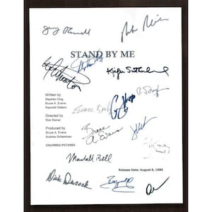 May include: A white sheet of paper with the title "STAND BY ME" and the release date August 8, 1986. The paper is signed by the cast and crew, including Rob Reiner, Stephen King, Bruce A. Evans, Raynold Gideon, Kiefer Sutherland, Wil Wheaton, River Phoenix, Corey Feldman, Jerry O'Connell, and Marshall Bell.