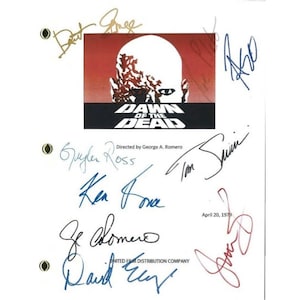 May include: A white sheet of paper with a black and white image of a zombie from the movie "Dawn of the Dead". The image is surrounded by a red border. The paper is signed by the cast and crew of the film, including George A. Romero, Ken Foree, and David Emmet.