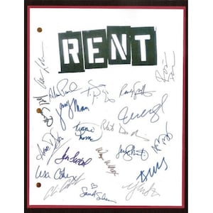 May include: A white sheet of paper with the word "RENT" in black letters. The paper is signed by multiple people, including the cast of the musical "Rent".