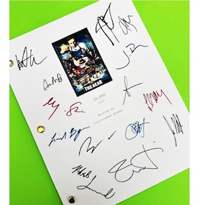 May include: A white script with the title "The Bear" and the text "Written by Christopher Stores" is signed by multiple people in blue, black, and red ink.