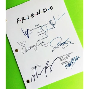 May include: A white script for the TV show "Friends" episode "The One With Fake Monica" with signatures from the cast and crew. The signatures include Courteney Cox, Jennifer Aniston, Matt LeBlanc, and Matthew Perry.