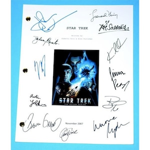 May include: A white script page with a blue and black movie poster for "Star Trek: The Original Series" with signatures from the cast and crew, including Zachary Quinto, Leonard Nimoy, Zoe Saldana, Simon Pegg, and J.J. Abrams.