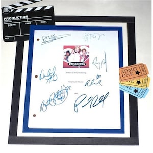 May include: A white script page from the movie "Clueless" with signatures from the cast and crew. The signatures include:  "Brace", "Alicia Silverstone", "Paul Rudd", "Brittany Murphy", "Donald Faison", and "Stacey Dash".  The script page also includes the movie title, "Clueless", and the words "Written by Amy Heckerling" and "Paramount Pictures".  There are also three yellow, orange, and blue "ADMIT ONE" tickets.