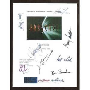 May include: A white paper with the Farscape logo and signatures. The logo is in gold and green, with the text "Farscape". The paper also includes the text "Premiere Episode One".