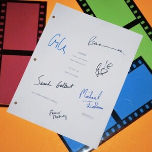 May include: A white script page with signatures from the cast and crew of the movie "Clue" including Sarah Gilbert, Michael Tishman, and others. The page includes the title "Clueless" and the words "Show Biz Stuff" and "The Carsey-Werner Company".