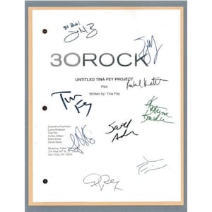May include: A white script with the title "30 Rock" and the words "UNTITLED TINA FEY PROJECT" and "Pilot" written on it. The script is signed by Tina Fey, several other people, and the words "30 B!" and "30 Rock!"
