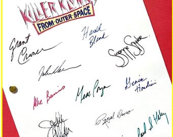 May include: A white sheet of paper with black, blue, green, pink, and purple signatures. The signatures are from the cast of the movie "Killer Klowns from Outer Space".
