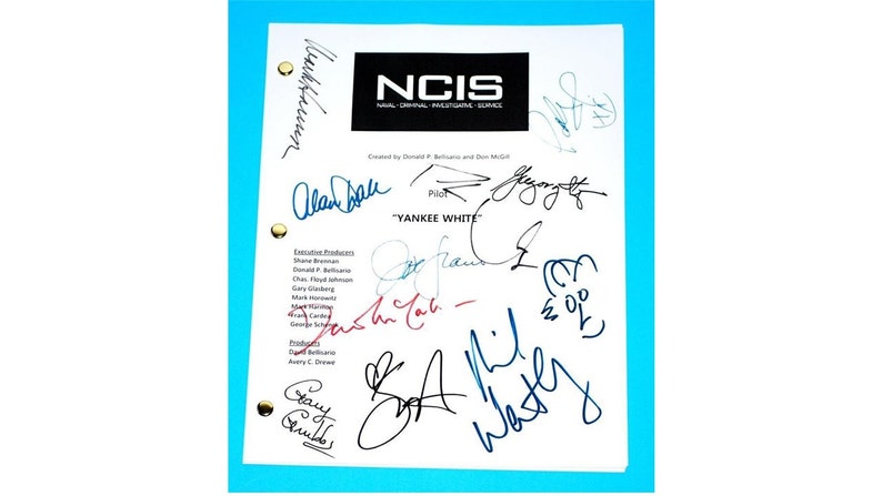 May include: A white script with the title "NCIS: Naval Criminal Investigative Service" and the episode title "Yankee White". The script is signed by several people, including the cast and crew.