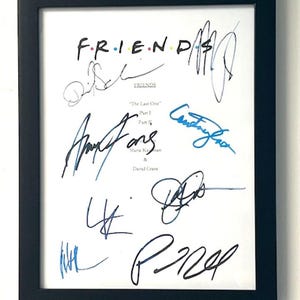 May include: A framed black and white print of the Friends TV show logo with the signatures of the six main cast members: Jennifer Aniston, Courteney Cox, Lisa Kudrow, Matt LeBlanc, Matthew Perry, and David Schwimmer. The print is titled "FRIENDS" and includes the episode title "The Last One" and the names of the writers, Marta Kauffman and David Crane.