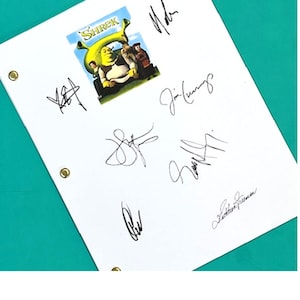 May include: White paper with multiple signatures and a small Shrek movie poster image. The poster features Shrek, Donkey, and other characters. The signatures are in black ink.