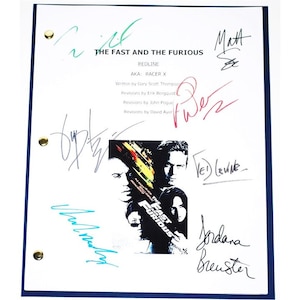 May include: A white script for "The Fast and the Furious: Redline" with multiple signatures in various colors. The script includes the film's title, the names of the writers, and a movie poster image.