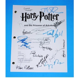 May include: A white script with the title "Harry Potter and the Prisoner of Azkaban" with several signatures in blue and black ink. The signatures include names like "Rupert Grint", "Daniel Radcliffe", and "Emma Watson".