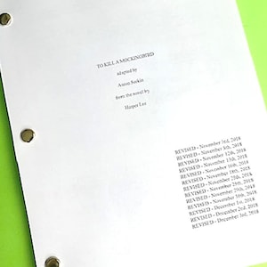 May include: A white script cover with the title "To Kill a Mockingbird" and the text "adapted by Aaron Sorkin from the novel by Harper Lee". The cover also lists the dates the script was revised.