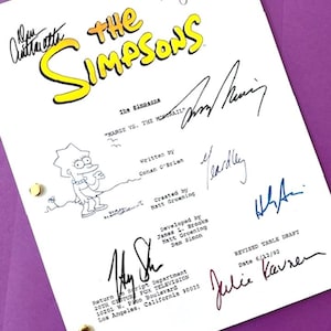 May include: A white script for "The Simpsons" episode "Marge vs. The Monorail", featuring signatures and a Lisa Simpson sketch. The script is dated 6/12/92 and includes the show's logo in yellow.