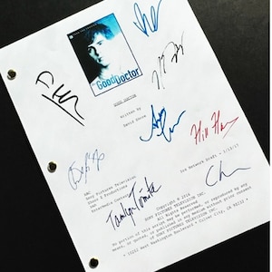 May include: A white script page with the title "The Good Doctor" and a photo of the show's main character. The page is signed by several people, including the show's creator, David Shore.