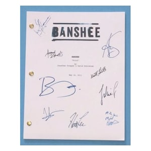 May include: A white script page for the TV show "Banshee" with the title in bold black letters. The page is signed by several people, including the show's creator Jonathan Tropper and the actors Ivana Milicevic, Matt Servitto, and Hoon Lee.