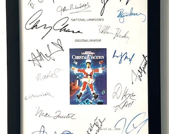 May include: A white framed poster with a movie poster for National Lampoon's Christmas Vacation. The poster features Chevy Chase as Clark Griswold. The poster is signed by the cast and crew, including Chevy Chase, Beverly D'Angelo, Juliette Lewis, Randy Quaid, John Candy, and more.