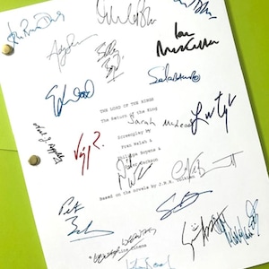 May include: A white script with multiple signatures in black, blue, and red ink. The text "THE LORD OF THE RINGS The Return of the King" is visible, along with names and the phrase "based on the novels by J.R.R. Tolkien."