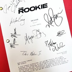 May include: A white script page for the TV show "The Rookie" with the title and episode name "Pilot" written in black text. The page is signed by several people, including the actors Nathan Fillion, Alyssa Diaz, Titus Makin Jr., and Melissa O'Neil. The page also includes the copyright information for Foxburg Productions, LLC and ABC Studios.