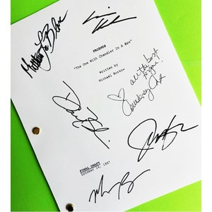 May include: A white script page with the title "FRIENDS" and the episode title "The One With Chandler In A Box". The page is signed by the cast members: Matthew Perry, Lisa Kudrow, Matt LeBlanc, Courteney Cox, David Schwimmer, and Jennifer Aniston.