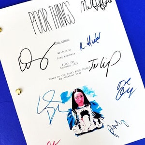 May include: A white script for the movie "Poor Things" with signatures from the cast and crew. The signatures include "K. Hunter", "Tulip", "Emma", and "Marti Noxon".
