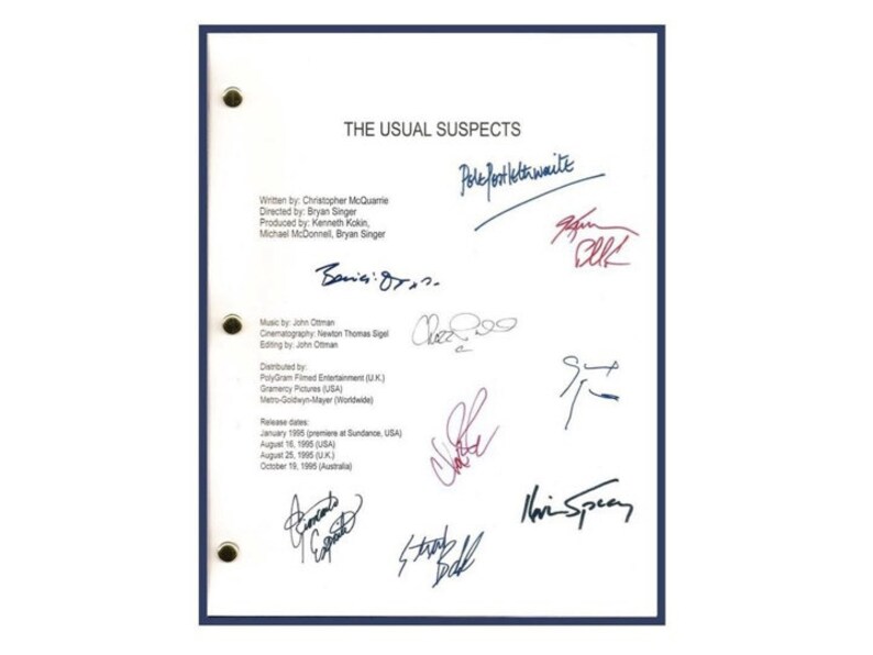 May include: A white sheet of paper with the title "The Usual Suspects" and a list of credits for the film. The paper is signed by several people, including the director, writer, and cinematographer.