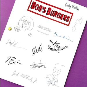 May include: A white sheet of paper with the words "Bob's Burgers" in a red box, surrounded by signatures and drawings. The paper is held in place by gold push pins. The background is purple.